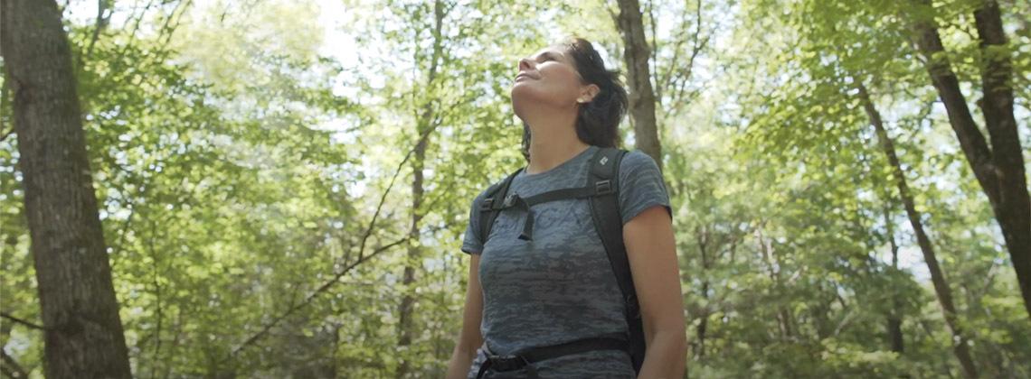 Woman hiking alone in the woods