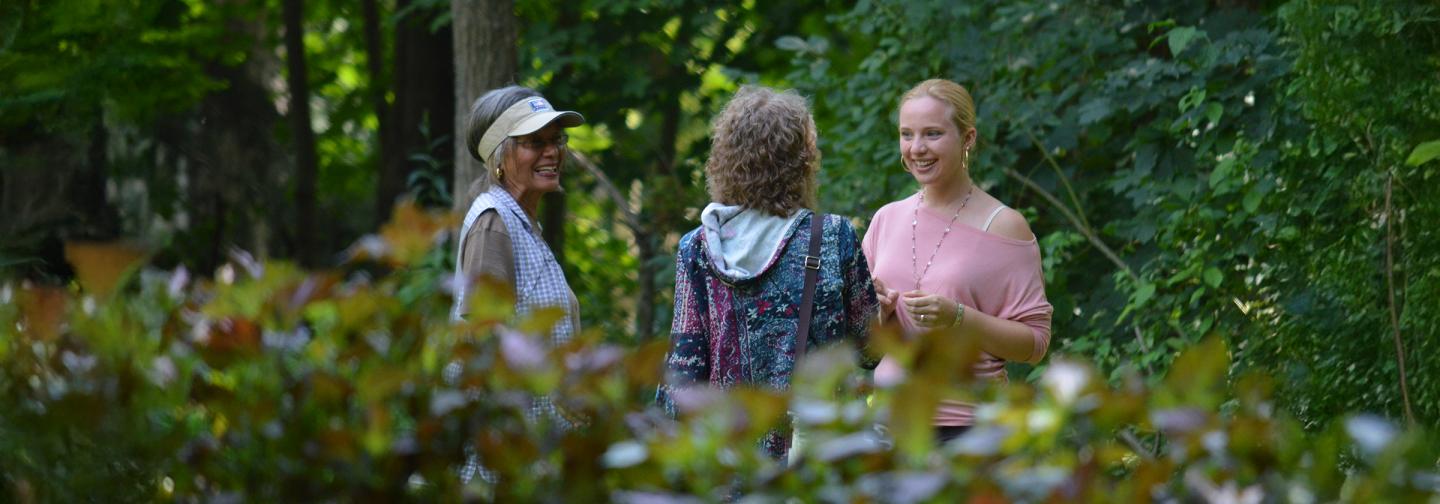 Omega participants having a conversation in the garden