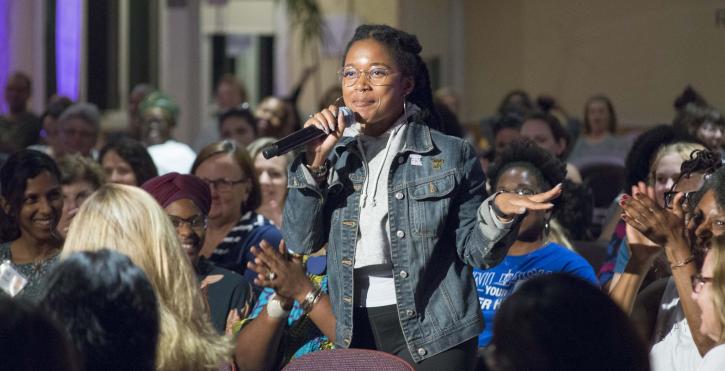 Woman speaks with microphone